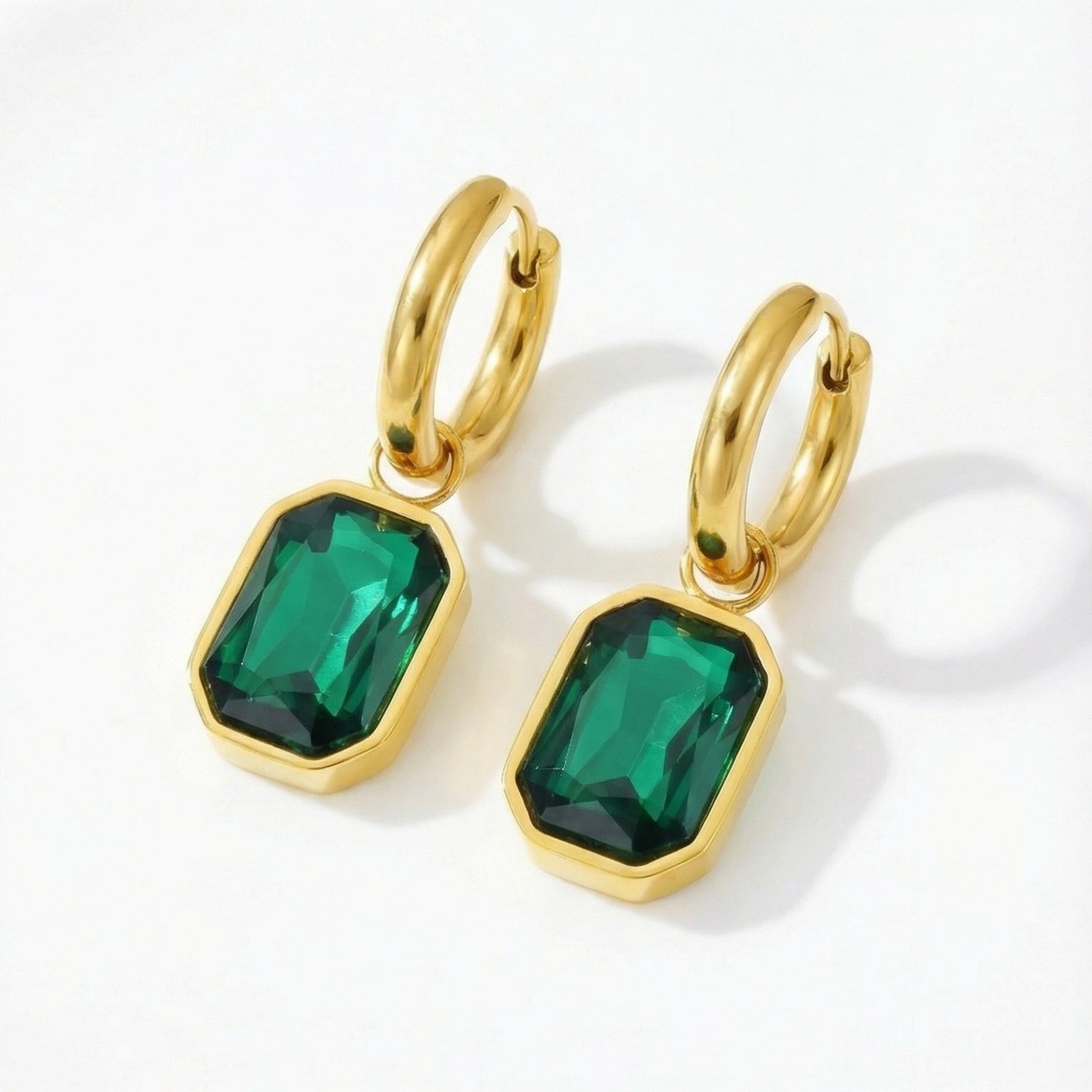 Emerald cut earrings with sparkling gemstones, showcasing elegant jewelry design and silver setting.